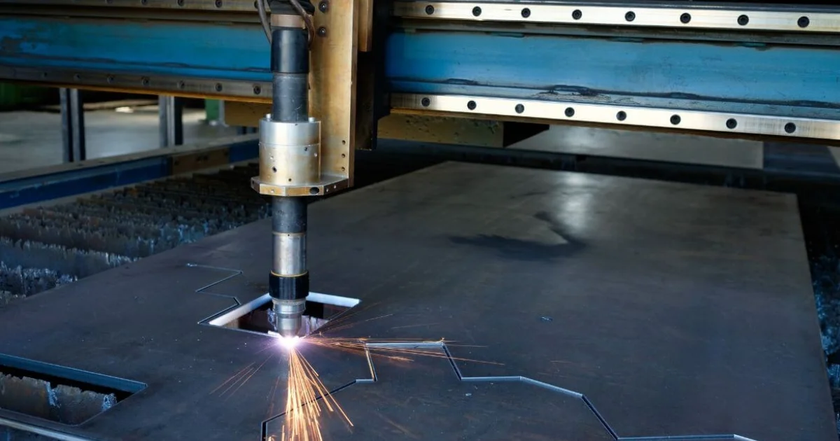 Plasma cutting torch cutting thick sheet metal on industrial machine